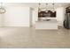 Open-concept area blending living space and kitchen, with modern appliances at 17425 W Eva St, Waddell, AZ 85355
