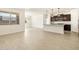 Open-concept living area showcasing the kitchen with modern pendants and stainless appliances at 17425 W Eva St, Waddell, AZ 85355