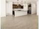 Open floor plan with modern kitchen, featuring a large island and stainless steel appliances at 17425 W Eva St, Waddell, AZ 85355