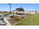Community picnic area with shaded seating, barbecue grills and desert landscaping on a sunny day at 17425 W Eva St, Waddell, AZ 85355