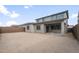 View of the house backyard with covered patio and cinder block wall at 17782 W Getty Dr, Goodyear, AZ 85338