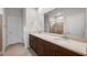 Bathroom featuring double sinks with a large mirror and a separate shower room at 17782 W Getty Dr, Goodyear, AZ 85338