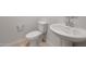 Powder room featuring a toilet and a white sink with a chrome faucet, and tile flooring at 17782 W Getty Dr, Goodyear, AZ 85338