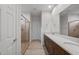 Modern bathroom featuring double sink vanity with stone countertop and glass enclosed shower at 17782 W Getty Dr, Goodyear, AZ 85338
