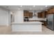 Modern kitchen with stainless steel appliances, a center island, and dark wood cabinets at 17782 W Getty Dr, Goodyear, AZ 85338