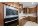 Close up of a stainless steel microwave and oven, complementing the kitchen's modern design and layout at 17782 W Getty Dr, Goodyear, AZ 85338