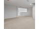 Large, open-concept living room featuring neutral carpet and plenty of natural light at 17782 W Getty Dr, Goodyear, AZ 85338