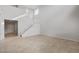 Spacious living space featuring tile flooring, tall ceilings, and a staircase leading to the upper level at 17782 W Getty Dr, Goodyear, AZ 85338