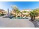 Resort-style pool with rock waterfall, basketball hoop, and lush landscaping for the ultimate backyard oasis at 2018 W Whisper Rock Trl, Phoenix, AZ 85085