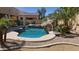 Inviting backyard pool features rock waterfall and lush landscaping, creating a private oasis for relaxation and recreation at 2018 W Whisper Rock Trl, Phoenix, AZ 85085
