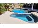 Inviting in-ground pool and spa with beautiful rock waterfall feature surrounded by lush landscaping and a spacious deck at 2018 W Whisper Rock Trl, Phoenix, AZ 85085
