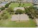 Discover community amenities: sand volleyball, basketball court, playground, and green space from above at 37341 W San Clemente St, Maricopa, AZ 85138