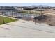 Community basketball court adjacent to pickleball courts, with mountain views at 37341 W San Clemente St, Maricopa, AZ 85138