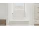 A bright bathroom showing a modern bathtub and shower stall under a window at 37341 W San Clemente St, Maricopa, AZ 85138