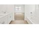 A bright bathroom with a combination of a bathtub, shower, and double sink vanity at 37341 W San Clemente St, Maricopa, AZ 85138