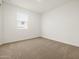 Clean bedroom with a neutral carpet, a window, and fresh white walls at 37341 W San Clemente St, Maricopa, AZ 85138