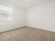Cozy bedroom with carpet, a window, and blank walls, ready for customization at 37341 W San Clemente St, Maricopa, AZ 85138