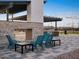 Relax by the stone fireplace with ample seating and outdoor kitchen in this vibrant community space at 37341 W San Clemente St, Maricopa, AZ 85138