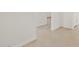 Bright hallway with neutral tile flooring and white walls, leading to other rooms at 37341 W San Clemente St, Maricopa, AZ 85138