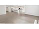 Open concept living space features tile flooring, recessed lighting, and easy access to the kitchen at 37341 W San Clemente St, Maricopa, AZ 85138