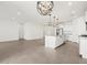 Open concept living space features tile flooring, recessed lighting, and modern pendant lighting above the island at 37341 W San Clemente St, Maricopa, AZ 85138