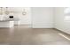 Open concept living space features tile flooring, recessed lighting, and easy access to the kitchen at 37341 W San Clemente St, Maricopa, AZ 85138