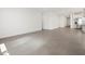 Open concept living space features tile flooring, recessed lighting, and easy access to the kitchen at 37341 W San Clemente St, Maricopa, AZ 85138