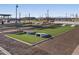 Recreation area with cornhole, seating, and well-maintained landscaping, perfect for community enjoyment at 37341 W San Clemente St, Maricopa, AZ 85138