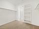 Bright walk-in closet features carpet flooring, shelving, hanging rods, and a view to the bathroom at 37341 W San Clemente St, Maricopa, AZ 85138