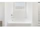 Bright bathroom featuring a soaking tub beneath a window, perfect for relaxation at 37373 W San Clemente St, Maricopa, AZ 85138