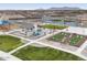 An aerial view of a community space showcasing a fireplace, seating, and a cornhole area for neighborhood enjoyment at 37373 W San Clemente St, Maricopa, AZ 85138