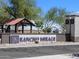Rancho Mirage community entrance featuring signage, desert landscaping and a covered gazebo at 37373 W San Clemente St, Maricopa, AZ 85138