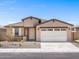 Inviting single-story home featuring a two-car garage, desert landscaping, and a covered front porch at 37373 W San Clemente St, Maricopa, AZ 85138