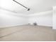 Spacious garage features a concrete floor and a large garage door at 37373 W San Clemente St, Maricopa, AZ 85138