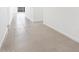 Bright hallway featuring neutral-colored tile flooring and leads into other rooms at 37373 W San Clemente St, Maricopa, AZ 85138
