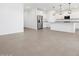 A spacious kitchen with stainless steel appliances, granite countertops, and modern pendant lighting fixtures at 37373 W San Clemente St, Maricopa, AZ 85138