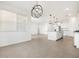 Open-concept living space with kitchen island, modern lighting, and spacious layout at 37373 W San Clemente St, Maricopa, AZ 85138