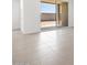 Covered outdoor patio with glass sliding doors with exterior block wall at 37373 W San Clemente St, Maricopa, AZ 85138