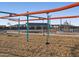 Community playground featuring swings and climbing equipment on a wood chip ground cover at 37373 W San Clemente St, Maricopa, AZ 85138