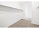 Empty walk-in closet with hanging racks, ready for organizing clothes and accessories at 37373 W San Clemente St, Maricopa, AZ 85138