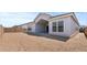 New construction home featuring a spacious dirt lot backyard and a covered patio at 42064 N Golden Trl, San Tan Valley, AZ 85140