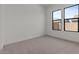Neutral bedroom showcases large windows and plush carpet flooring, perfect for relaxation at 42064 N Golden Trl, San Tan Valley, AZ 85140