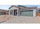 Exterior of home with a well manicured front yard, paved driveway, and a 2-car garage at 42064 N Golden Trl, San Tan Valley, AZ 85140