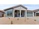 Charming single-story home featuring a stylish covered entry, two-car garage, and desert landscaping at 42064 N Golden Trl, San Tan Valley, AZ 85140