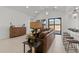 Comfortable living room area with leather sofa, stylish decor, and access to the kitchen at 42064 N Golden Trl, San Tan Valley, AZ 85140