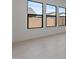 Bright living room with large windows, modern baseboards, and neutral walls at 42064 N Golden Trl, San Tan Valley, AZ 85140