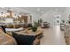 Open-concept living area features a large sectional couch, dining table, and views into the kitchen with stainless steel appliances at 42064 N Golden Trl, San Tan Valley, AZ 85140