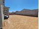 Large backyard with block fence offers ample space for outdoor activities and landscaping at 4347 W Hannah St, San Tan Valley, AZ 85144