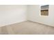 Cozy bedroom with neutral carpet and a window providing natural light at 4347 W Hannah St, San Tan Valley, AZ 85144