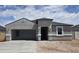 Charming single-story home with a stucco exterior, arched entry, and attached carport at 5712 E Axle Ln, San Tan Valley, AZ 85140